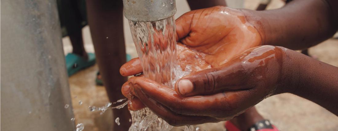 hands reaching out to water