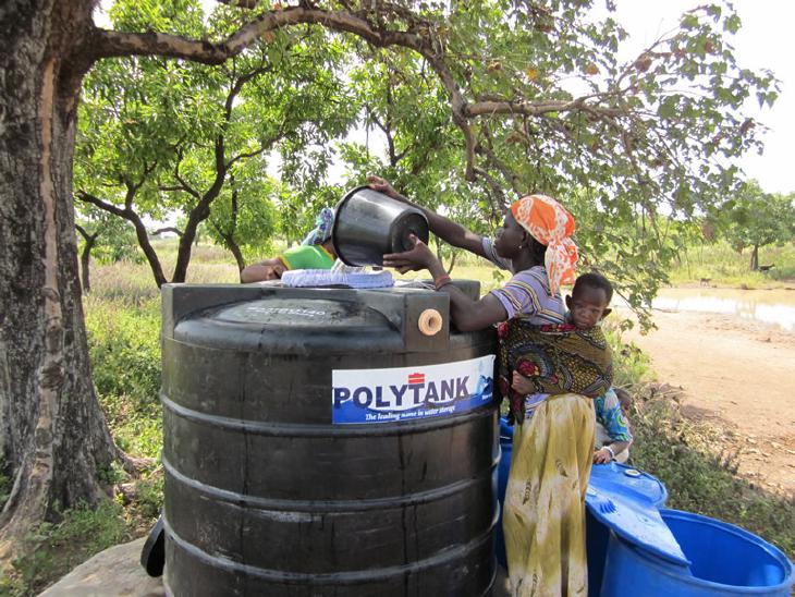 woman with child filling water conditioning tank